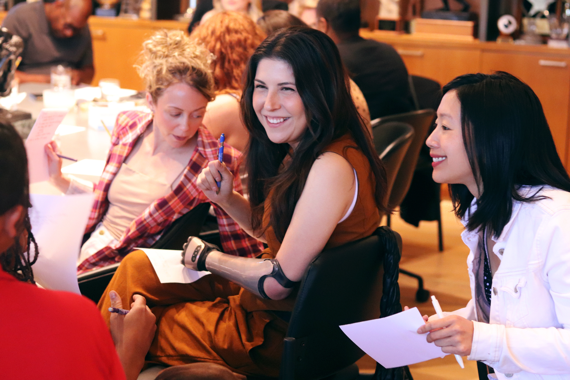 Members laughing and collaborating at a Making Space workshop table